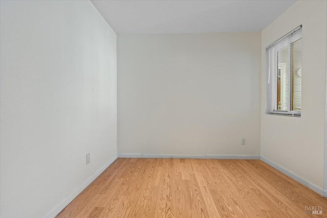 unfurnished room with light hardwood / wood-style flooring