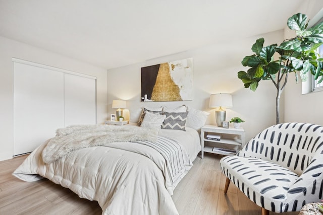 bedroom featuring light hardwood / wood-style flooring and a closet