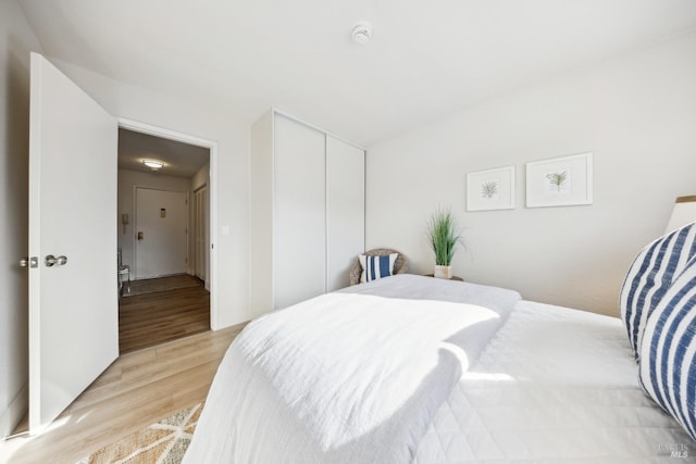 bedroom featuring a closet and light wood-type flooring