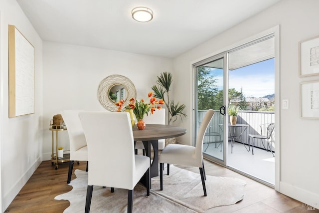 dining space with hardwood / wood-style floors