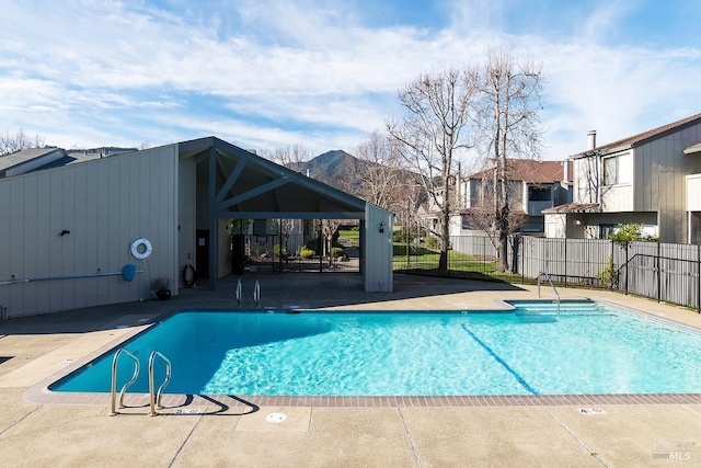 view of pool with a patio and a mountain view