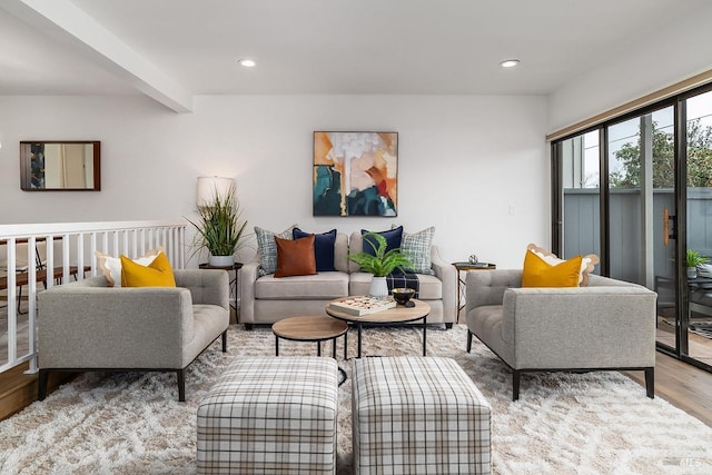 living room with light wood-type flooring and beam ceiling