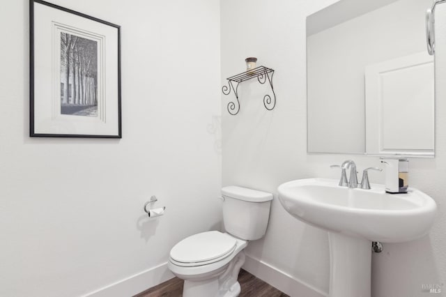 bathroom featuring sink, hardwood / wood-style floors, and toilet