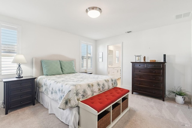 carpeted bedroom featuring ensuite bathroom