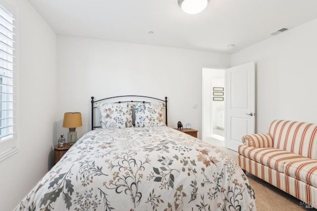 bedroom featuring multiple windows and carpet