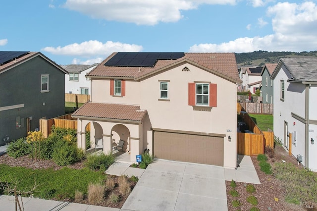 view of front facade featuring a garage and solar panels