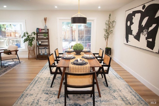 dining space with light wood finished floors, recessed lighting, and baseboards