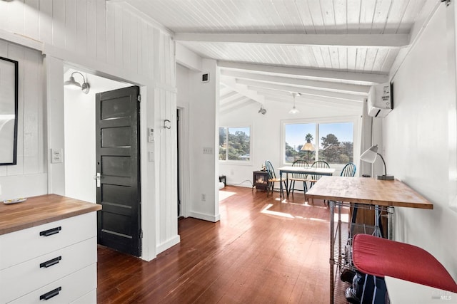 dining room featuring vaulted ceiling with beams, a wall mounted air conditioner, and dark hardwood / wood-style floors