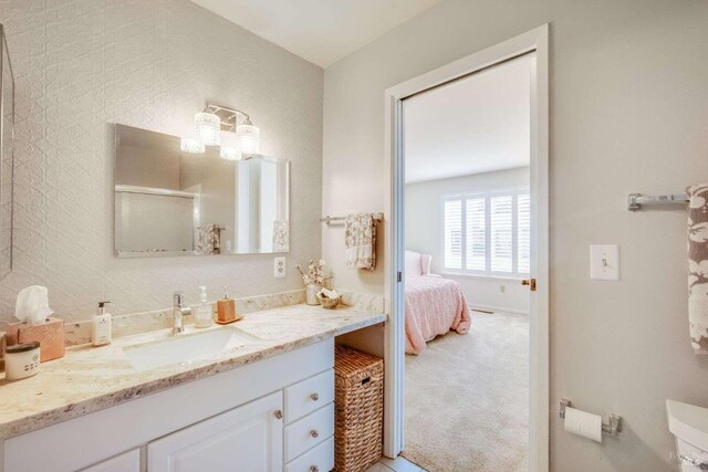 bathroom with walk in shower and vanity