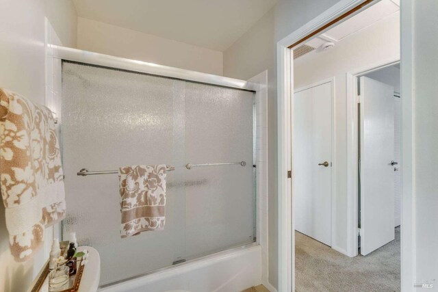 bathroom with shower / bath combination with glass door