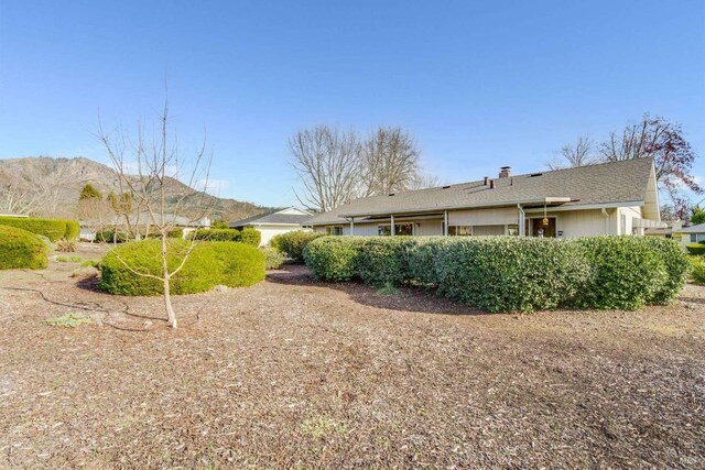 back of house featuring a mountain view