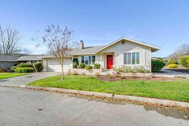 ranch-style house with a front lawn and a garage