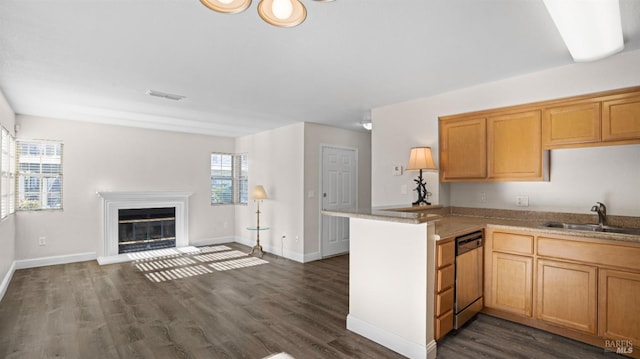 kitchen featuring sink, dark hardwood / wood-style floors, dishwasher, and kitchen peninsula