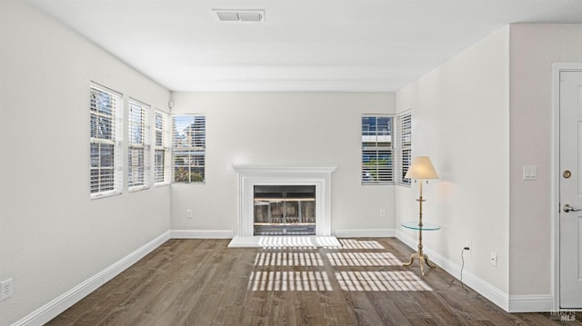 unfurnished living room with dark hardwood / wood-style floors