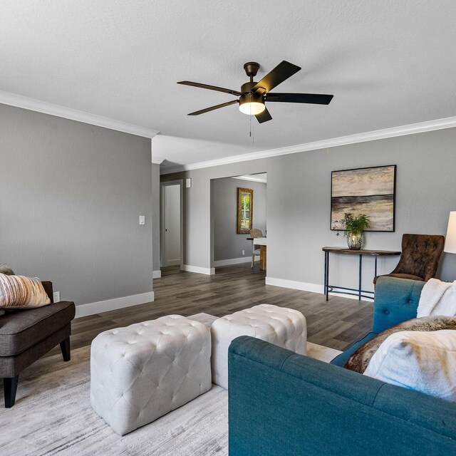 living room with crown molding and hardwood / wood-style floors