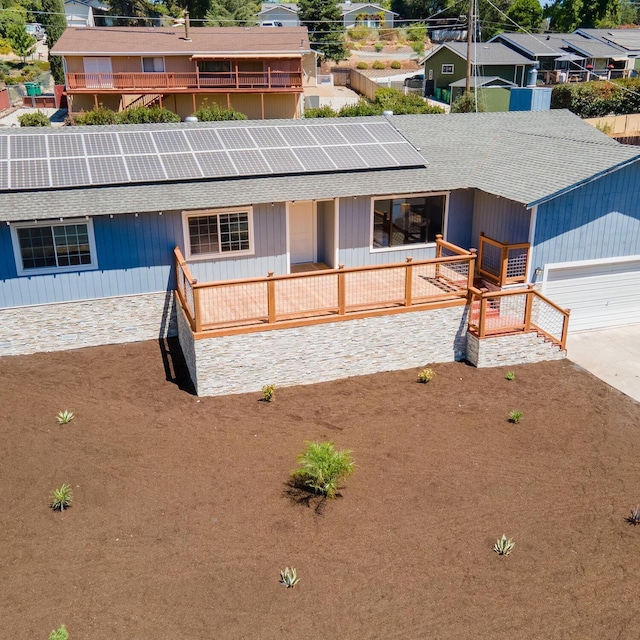 view of front of home with a garage and solar panels