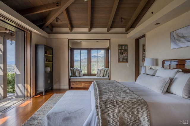 bedroom featuring vaulted ceiling with beams, wood ceiling, and hardwood / wood-style floors