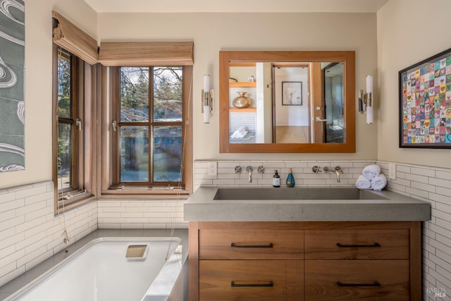 bathroom with vanity and a tub