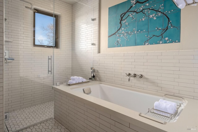 bathroom featuring shower with separate bathtub