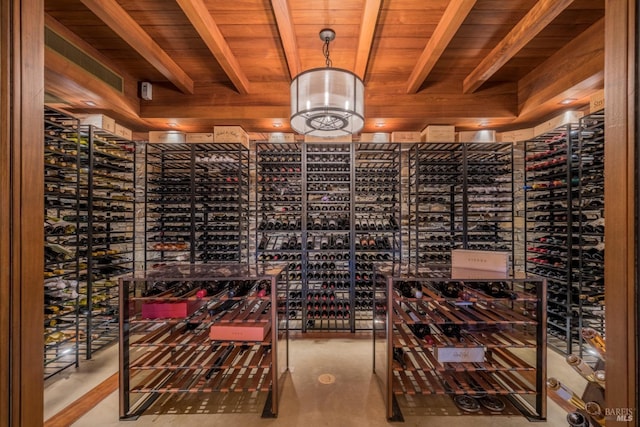 wine room featuring beam ceiling and wood ceiling