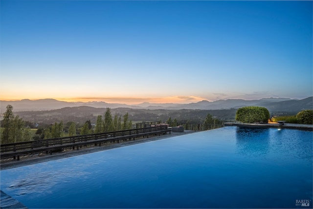 pool at dusk with a mountain view