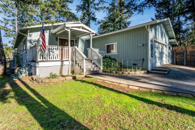 view of front of house with a porch, a garage, and a front yard