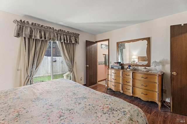 bedroom featuring dark wood-type flooring and access to outside