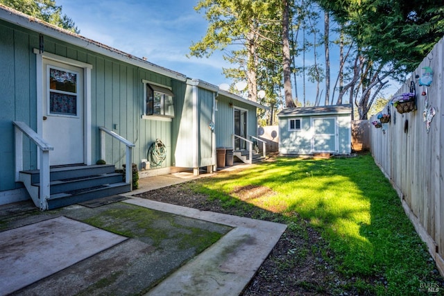 view of yard featuring a storage unit and a patio area