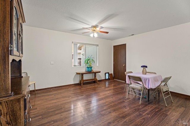 dining space featuring a textured ceiling, dark hardwood / wood-style floors, and ceiling fan