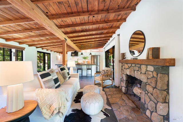 living room featuring a fireplace, wood ceiling, and beamed ceiling