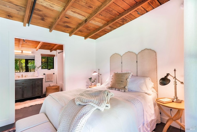 bedroom with ensuite bathroom, lofted ceiling with beams, wood ceiling, and sink