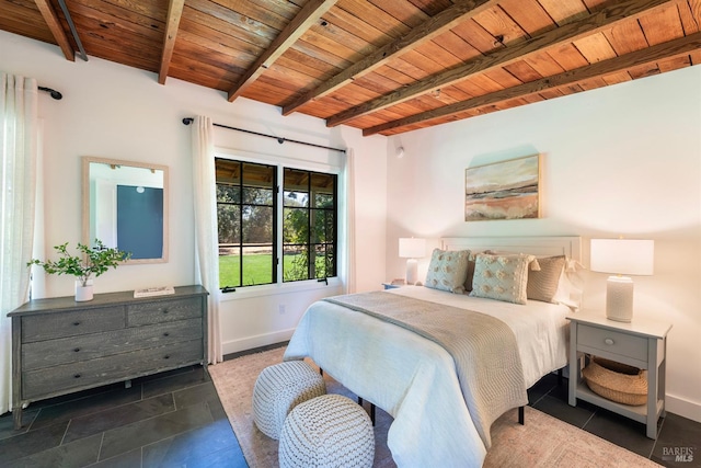 bedroom with dark tile patterned floors, wooden ceiling, and beamed ceiling