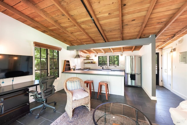 living room with a wealth of natural light, wood ceiling, and vaulted ceiling with beams