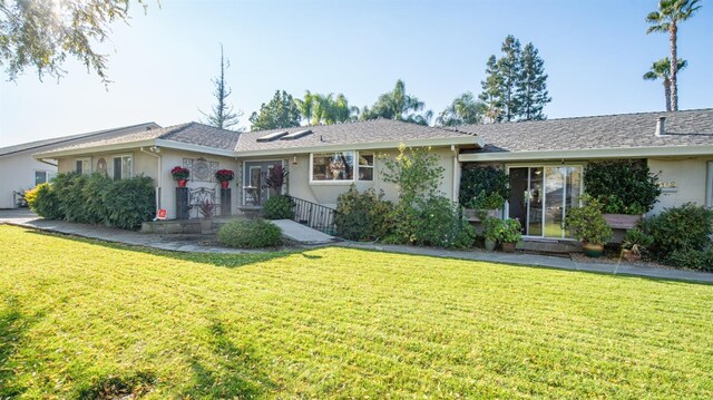 ranch-style house with a front lawn