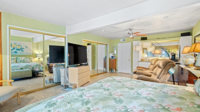 1403 Rowena Way, Sacramento, CA 95864 - tiled bedroom featuring two closets and beam ceiling