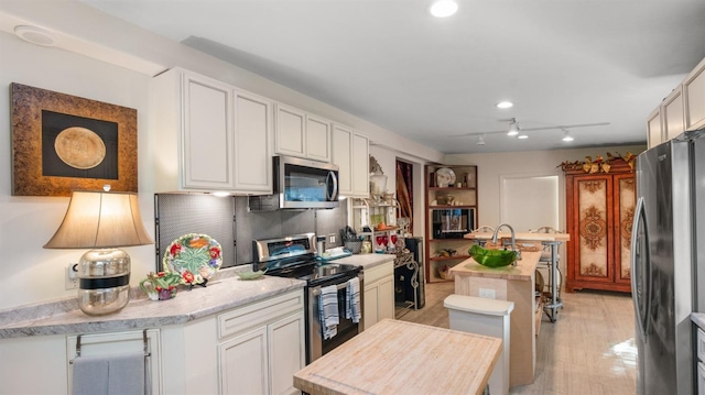 1403 Rowena Way, Sacramento, CA 95864 - kitchen with stainless steel appliances, white cabinets, and recessed lighting