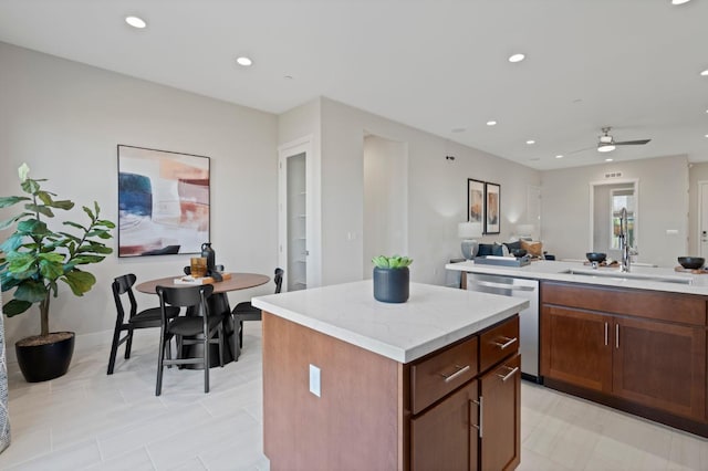 kitchen featuring recessed lighting, open floor plan, a kitchen island, a sink, and dishwasher