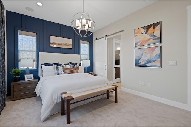 bedroom featuring light carpet, a barn door, baseboards, ensuite bathroom, and recessed lighting