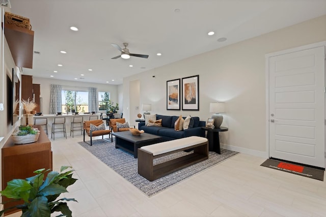 living room with recessed lighting, ceiling fan, and baseboards