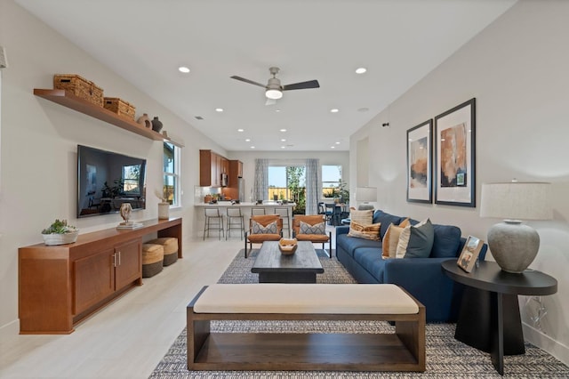 living area featuring ceiling fan and recessed lighting