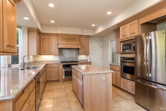 kitchen featuring premium range hood, a sink, a kitchen island, stainless steel appliances, and light stone countertops