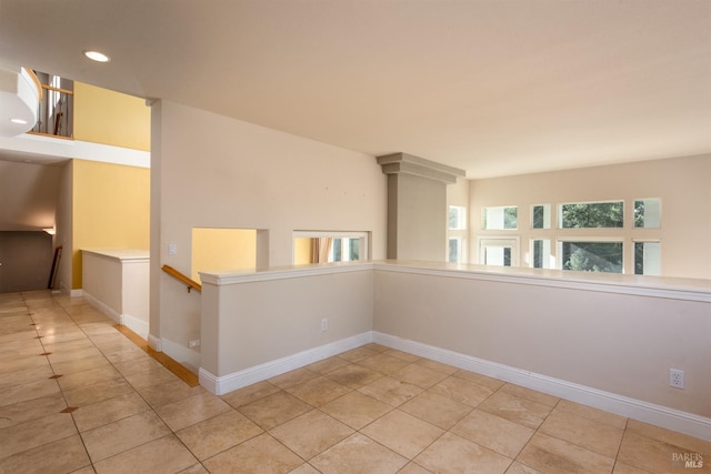 tiled spare room featuring recessed lighting and baseboards