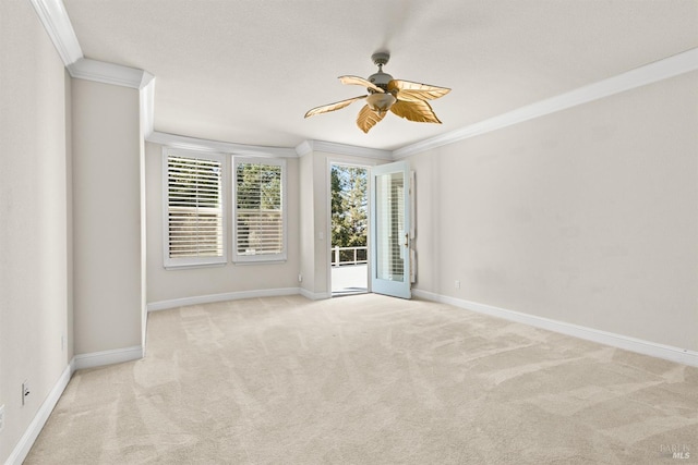 unfurnished room featuring light carpet, ceiling fan, crown molding, and baseboards