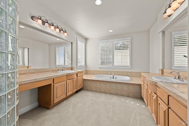 full bathroom with a sink, a garden tub, and two vanities