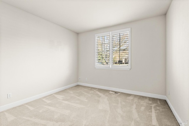 unfurnished room featuring baseboards and carpet