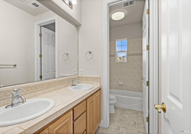 full bath featuring visible vents, toilet, and a sink