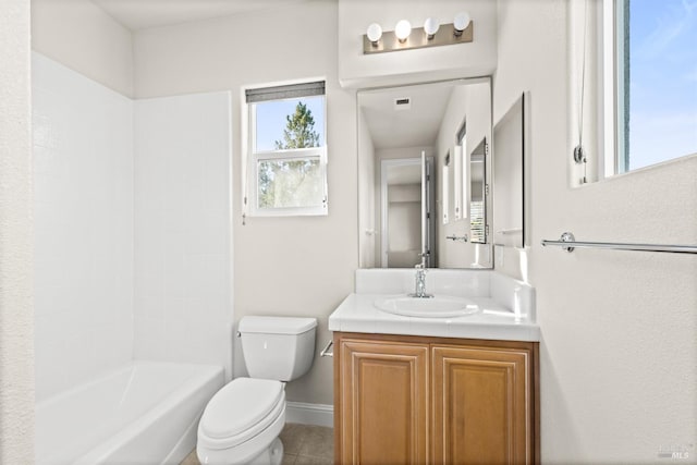 bathroom with baseboards, toilet, vanity, and tile patterned flooring