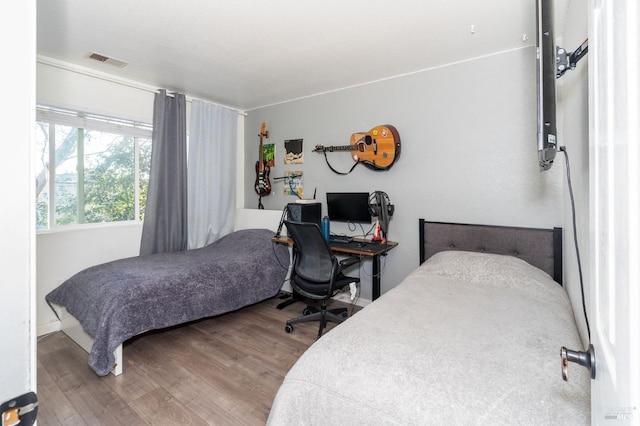 bedroom with hardwood / wood-style floors