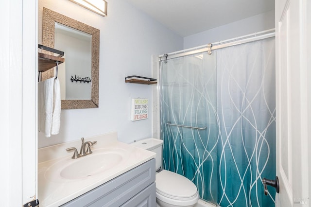 bathroom featuring toilet, a shower with shower curtain, and vanity