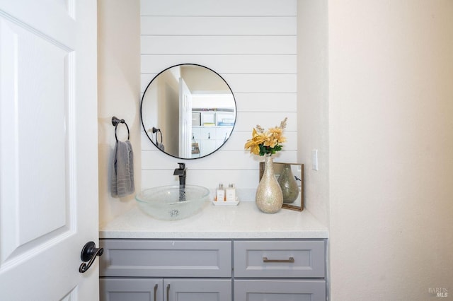 bathroom with wooden walls and vanity